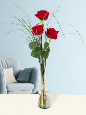 Three red roses, including vase