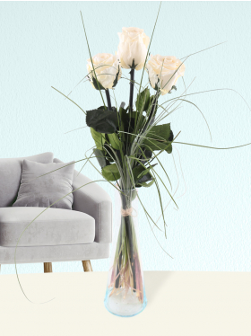 Three cream-coloured long life roses including vase